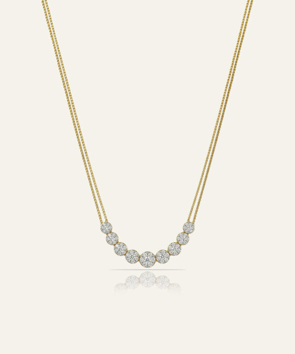 Gold necklace with small diamonds on a light beige background