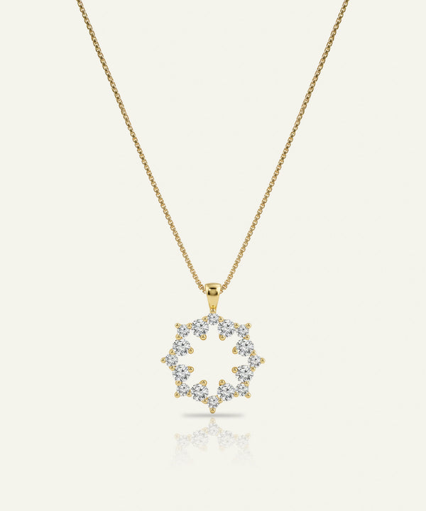 Gold necklace with a diamond pendant on a white background