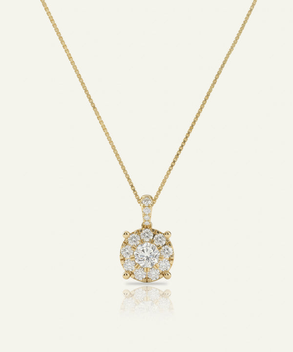 Gold necklace with a diamond pendant on a light beige background