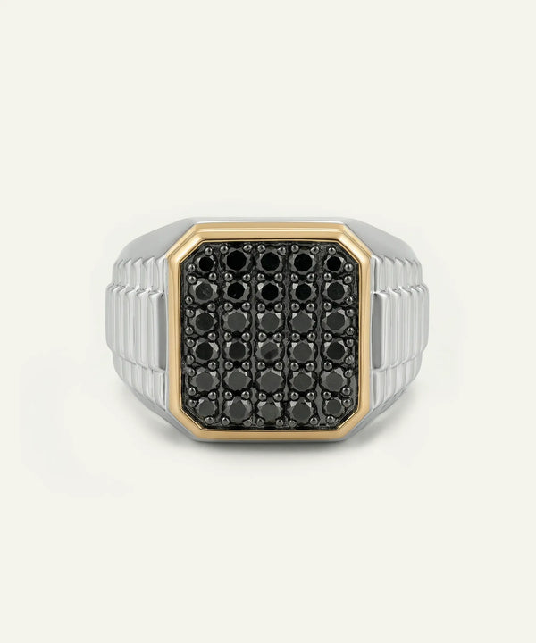 Silver ring with black gemstones on a white background