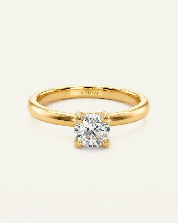 Gold ring with a diamond on a white background