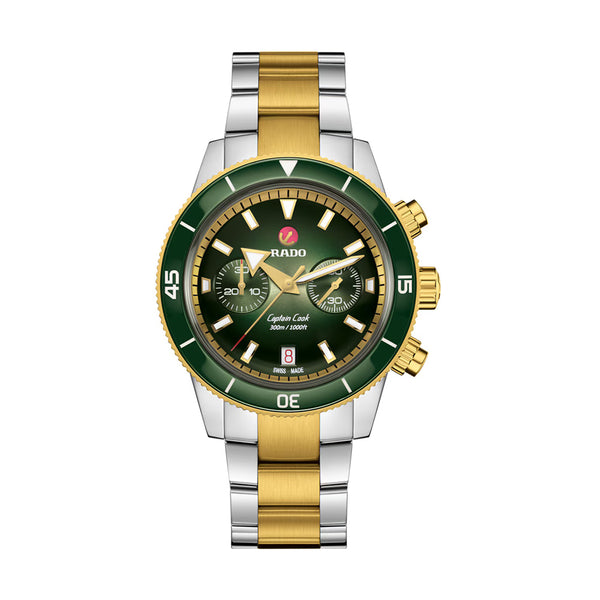 Rado watch with green face and gold and silver band on white background