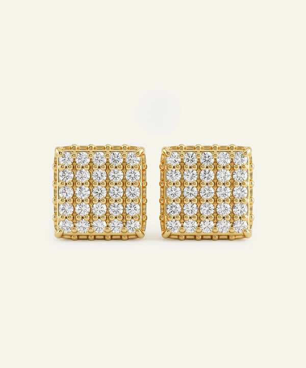 Gold square earrings with clear gemstones on a white background