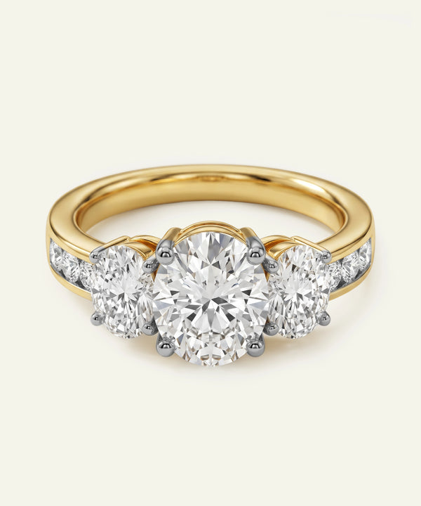 Gold ring with three diamond stones on a white background