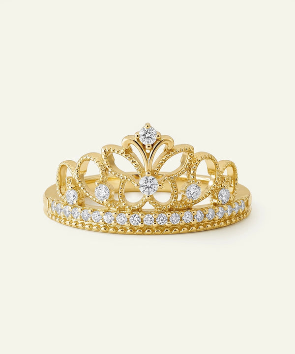 Gold tiara with diamonds on a light beige background