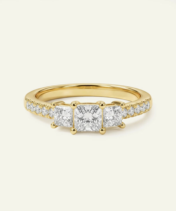 Gold ring with diamond stones on a white background