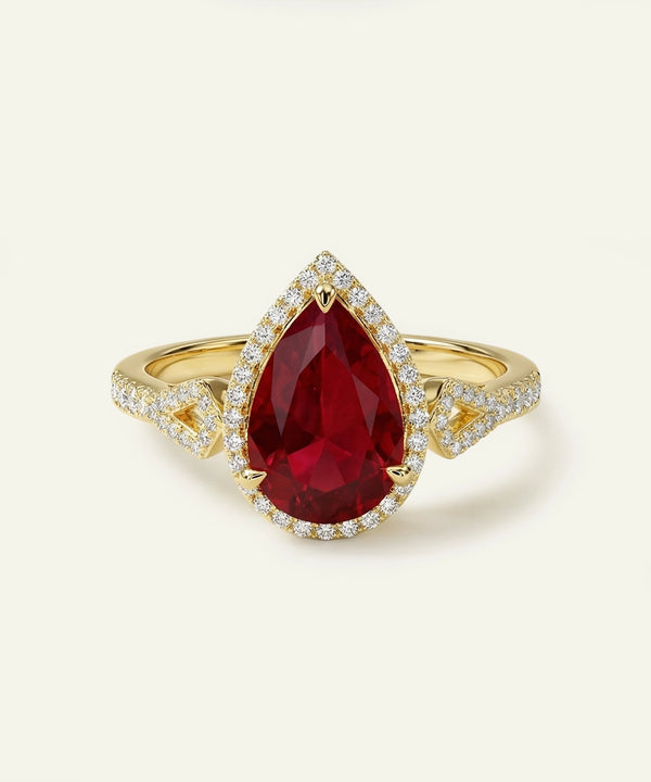 Gold ring with a large red gemstone on a white background
