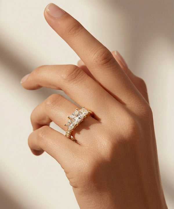 Hand wearing a rose gold ring with diamonds on a soft background