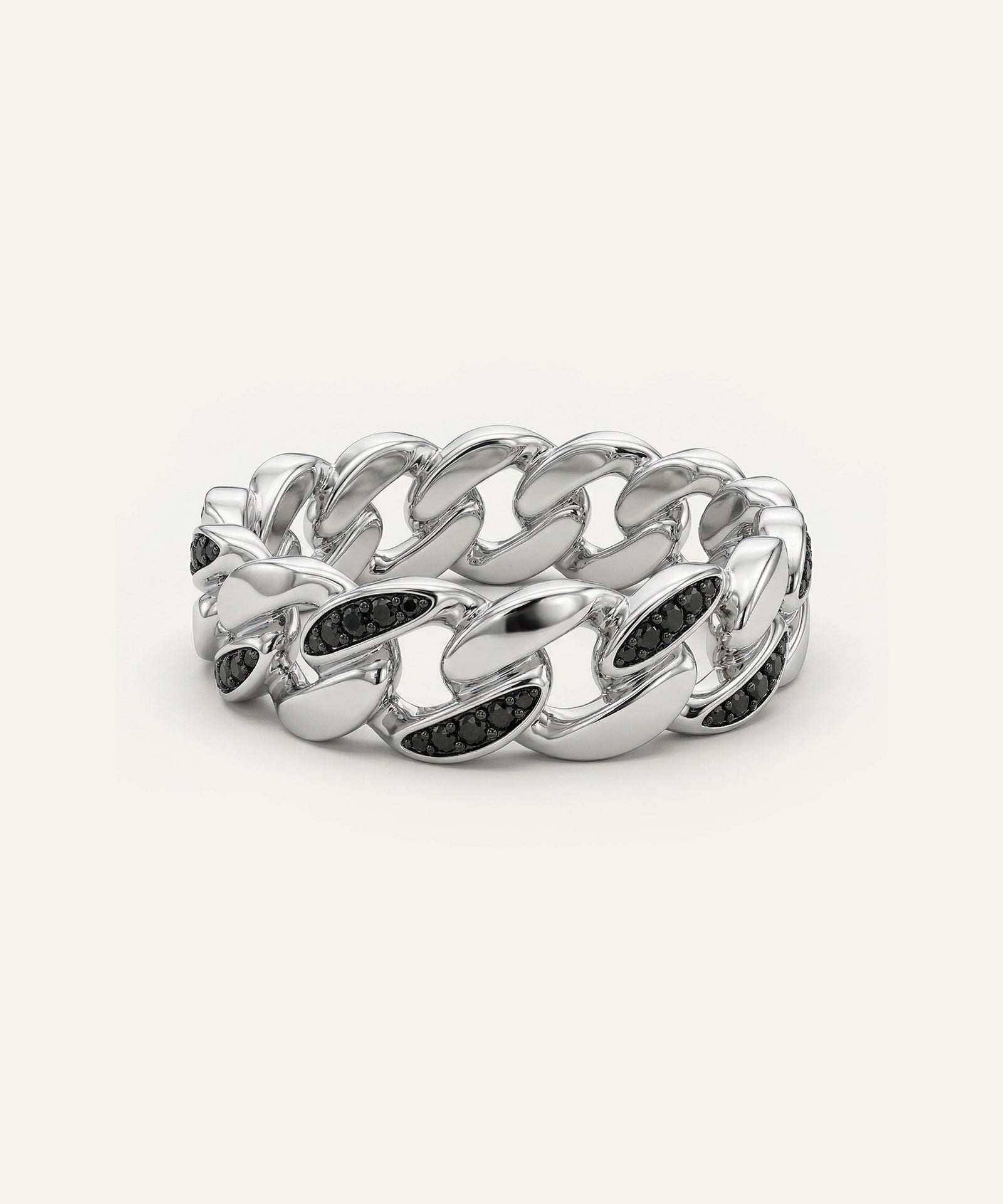 Silver chain ring with black stones on a white background