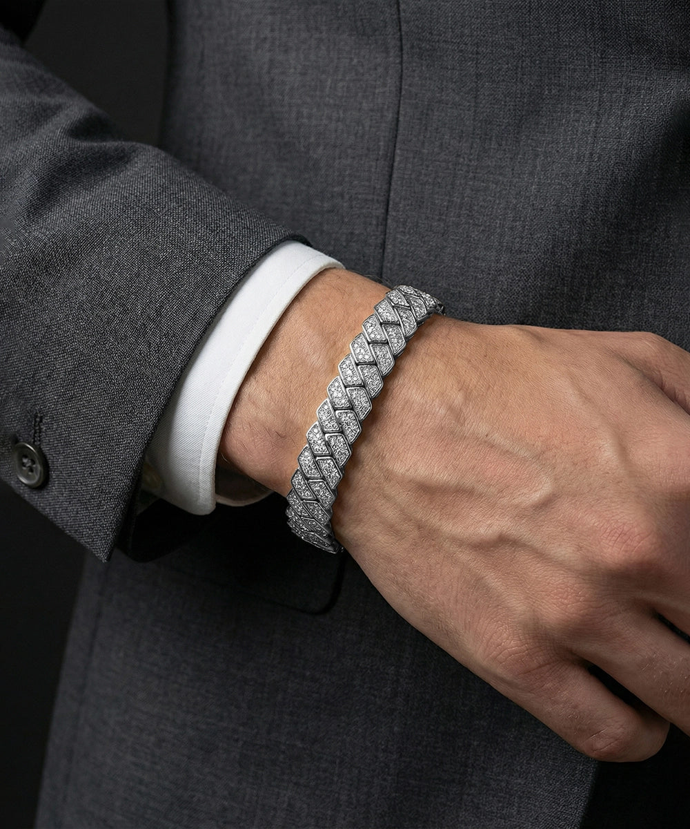 Silver braided bracelet on a person wearing a gray suit.