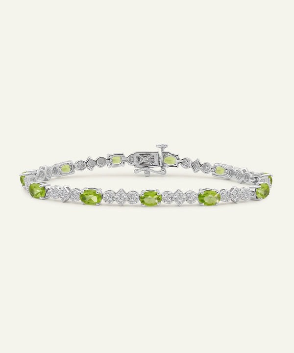 Peridot and diamond bracelet on a white background