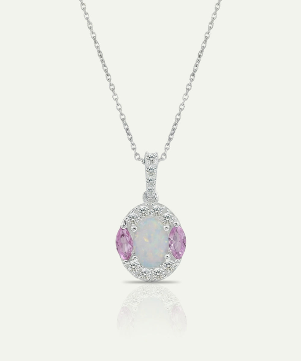 Silver pendant with pink gemstone and chain on a white background