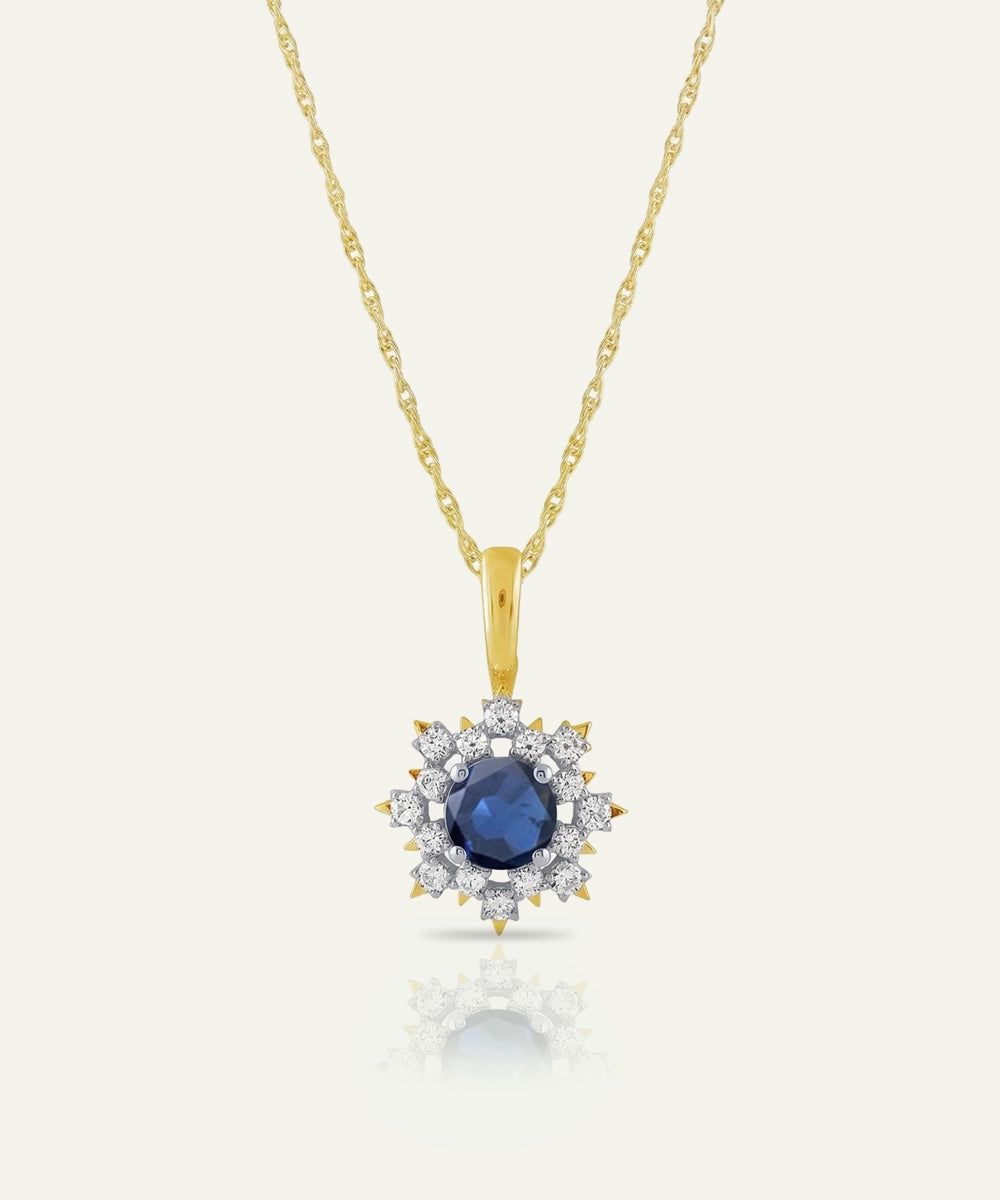 Gold necklace with a blue gemstone pendant on a white background