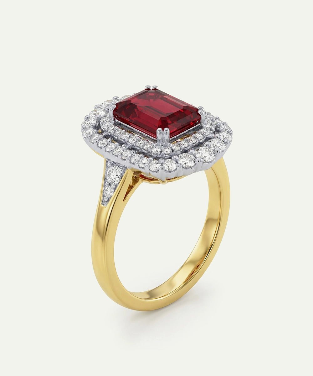 Gold ring with a red gemstone and diamond accents on a white background