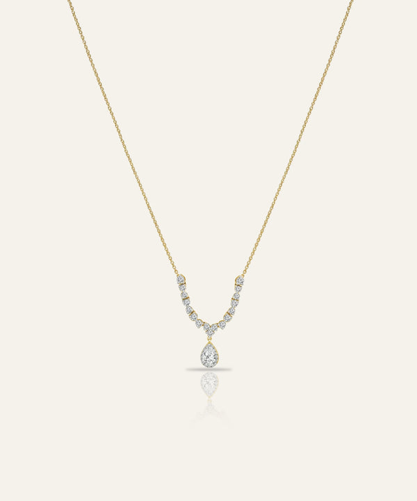 Gold necklace with a diamond pendant on a white background