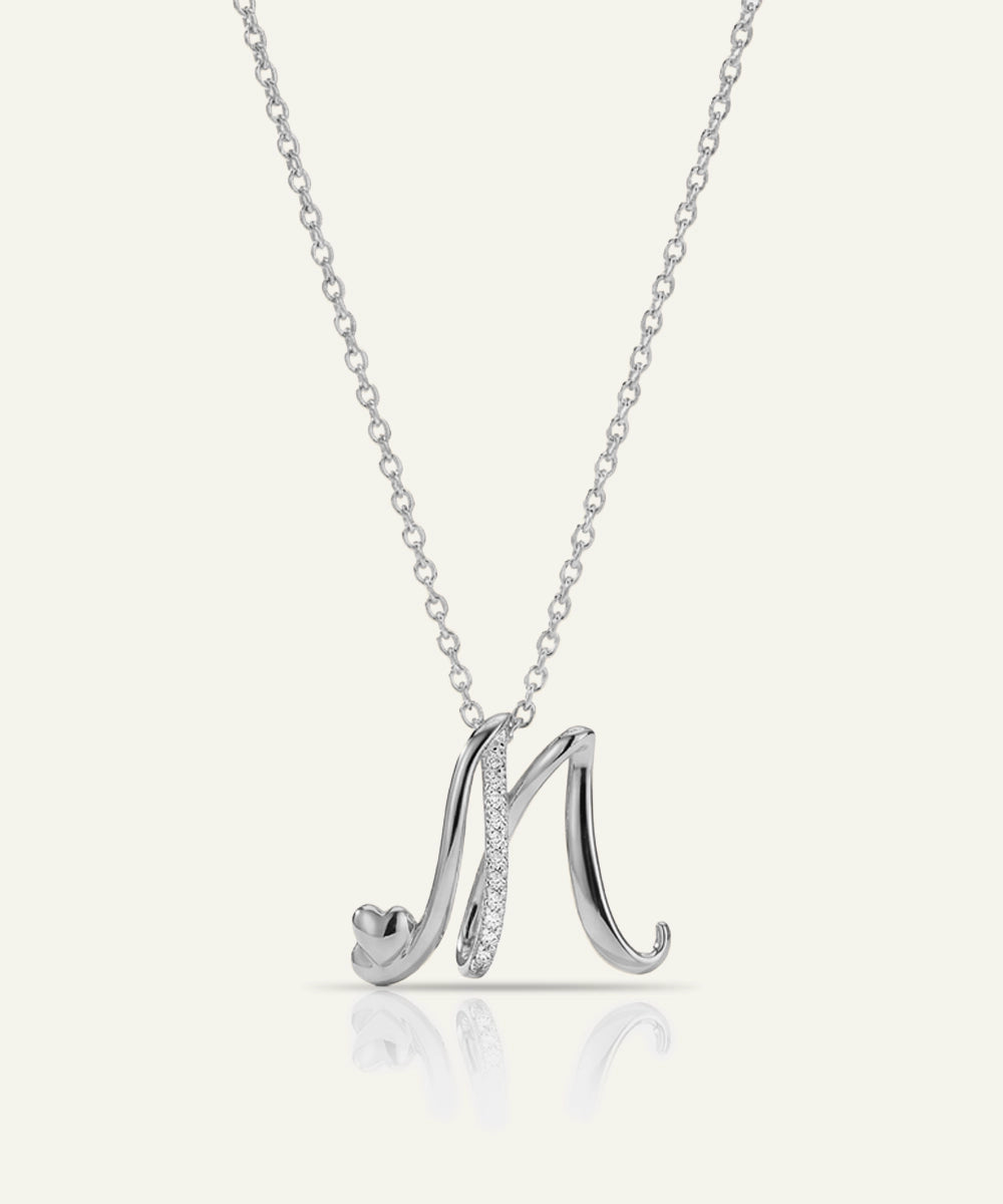Silver necklace with a 'M' pendant on a white background