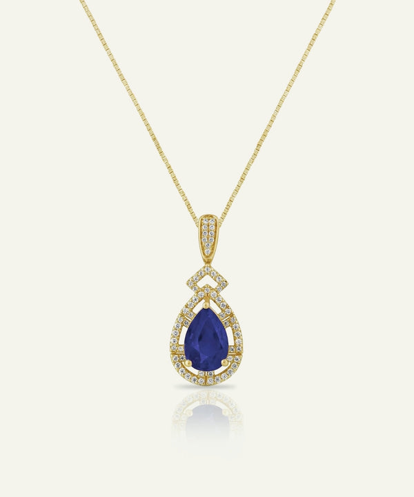 Gold necklace with a blue teardrop pendant on a white background