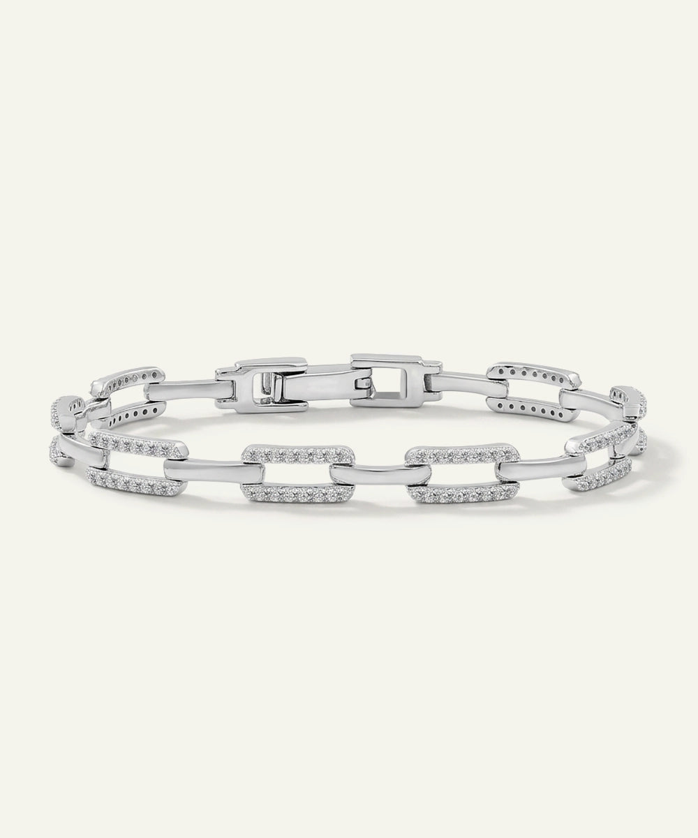 Silver bracelet with chain links on a light gray background
