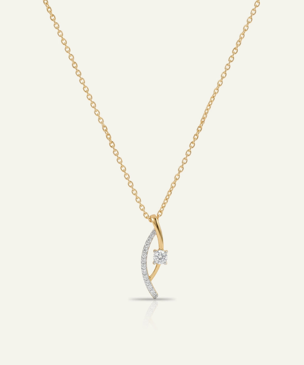 Gold and silver necklace with a crescent moon pendant on a white background
