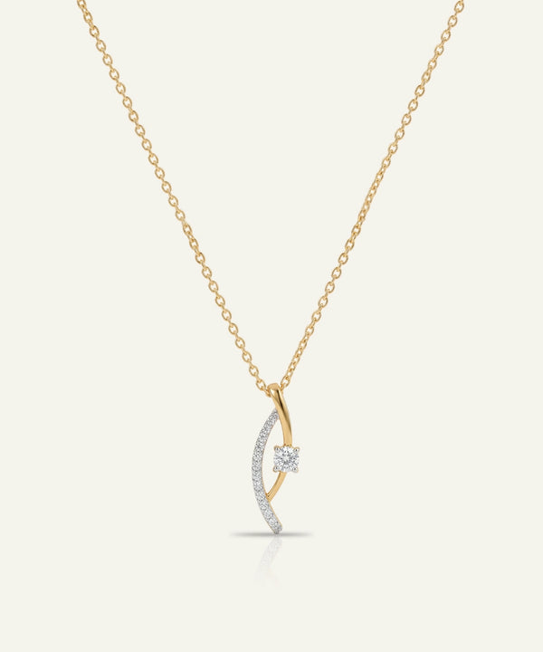 Gold and silver necklace with a crescent moon pendant on a white background