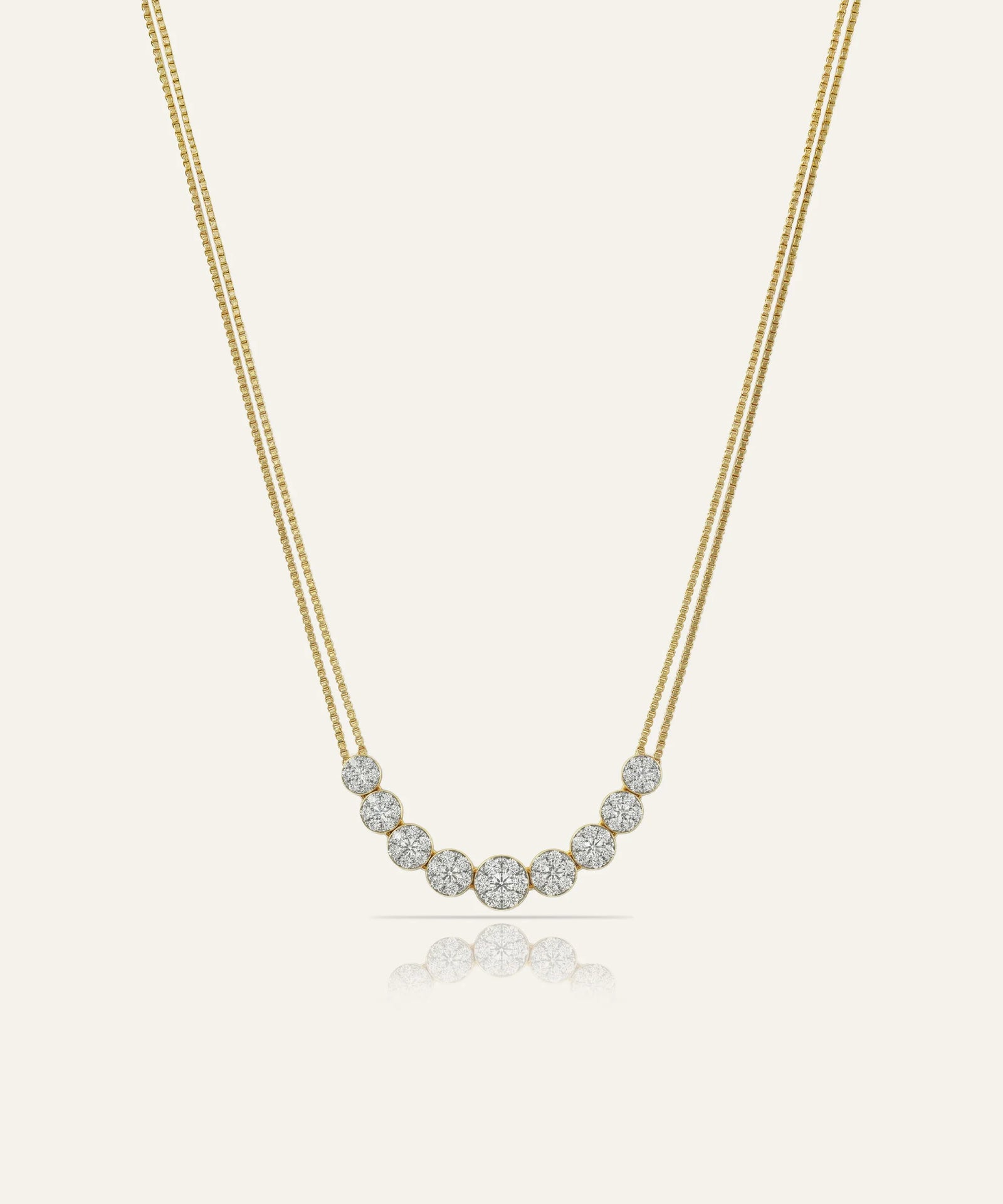 Gold necklace with small diamonds on a light beige background