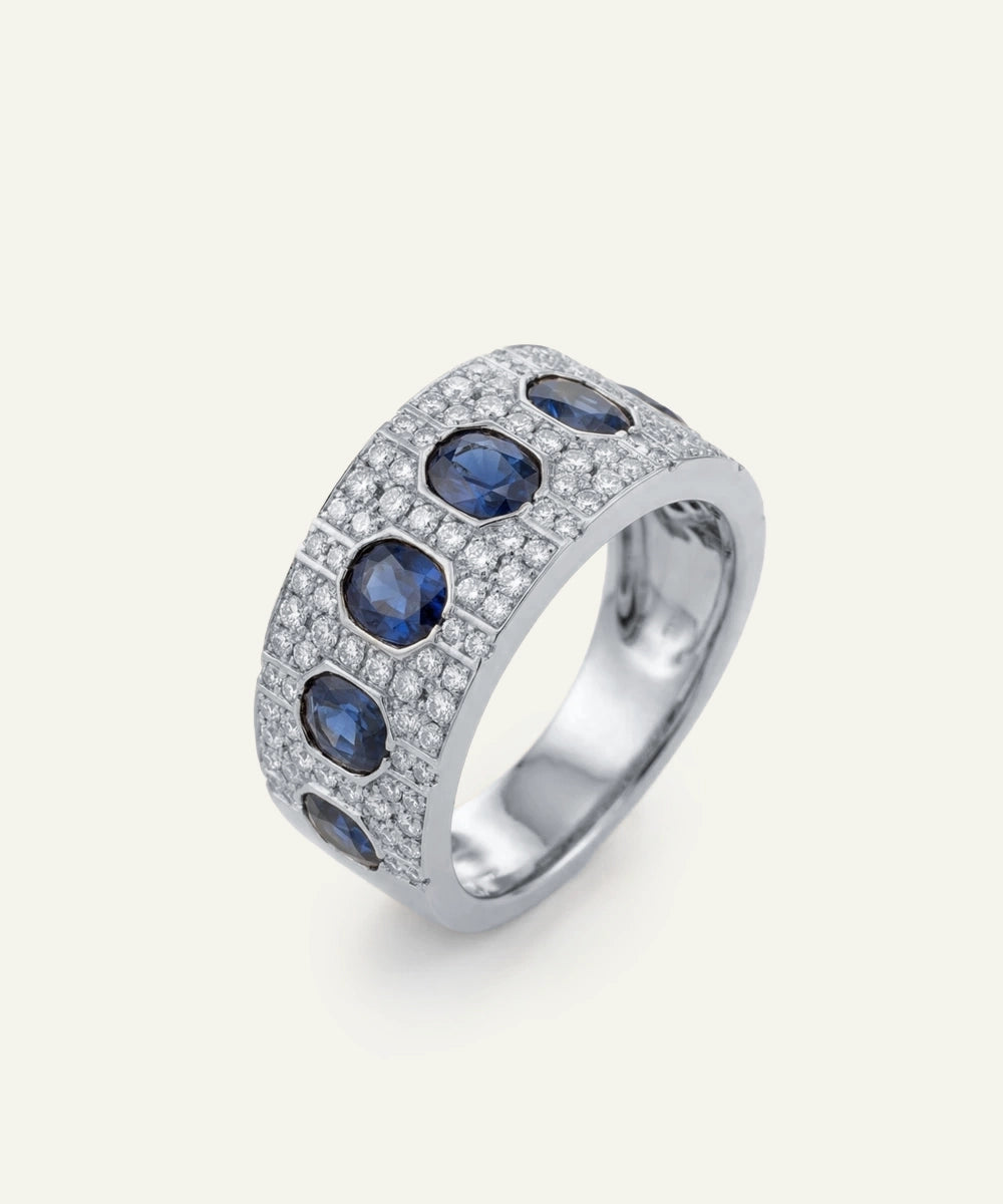 Silver ring with blue gemstones on a white background