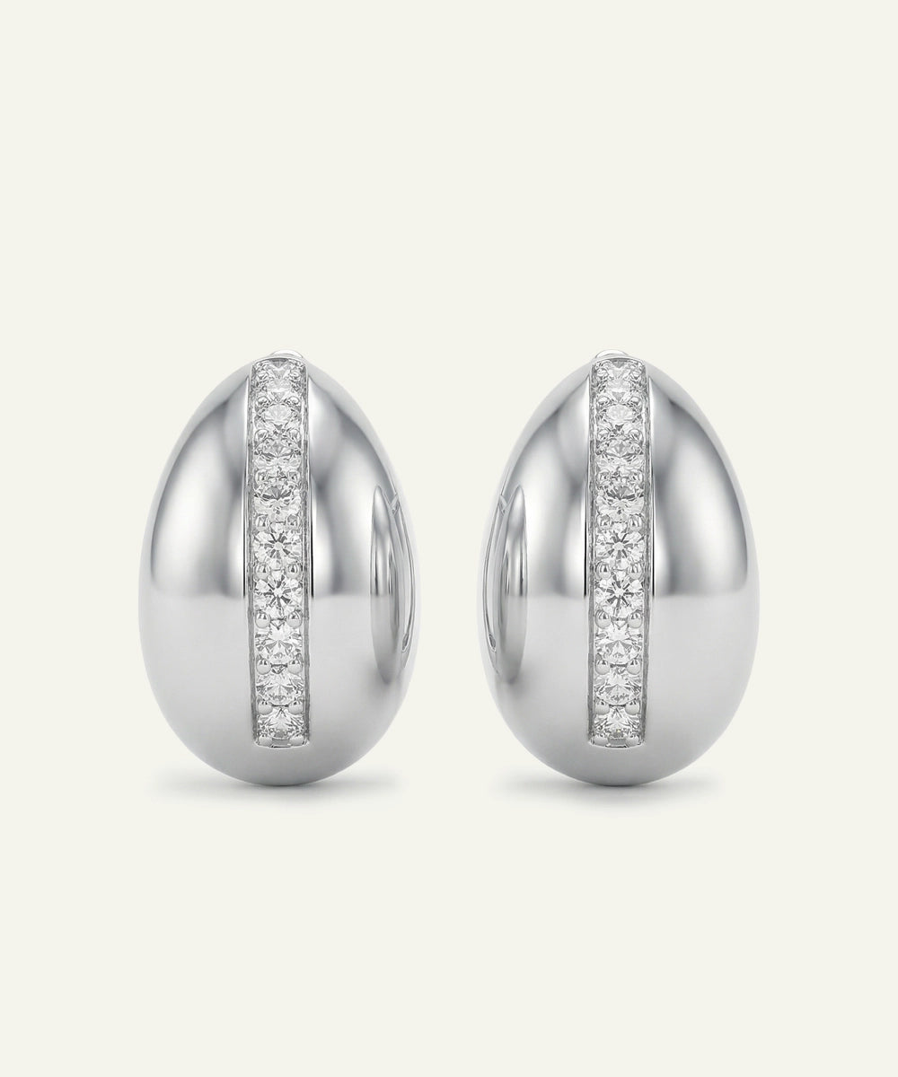 Pair of silver earrings with diamond accents on a white background