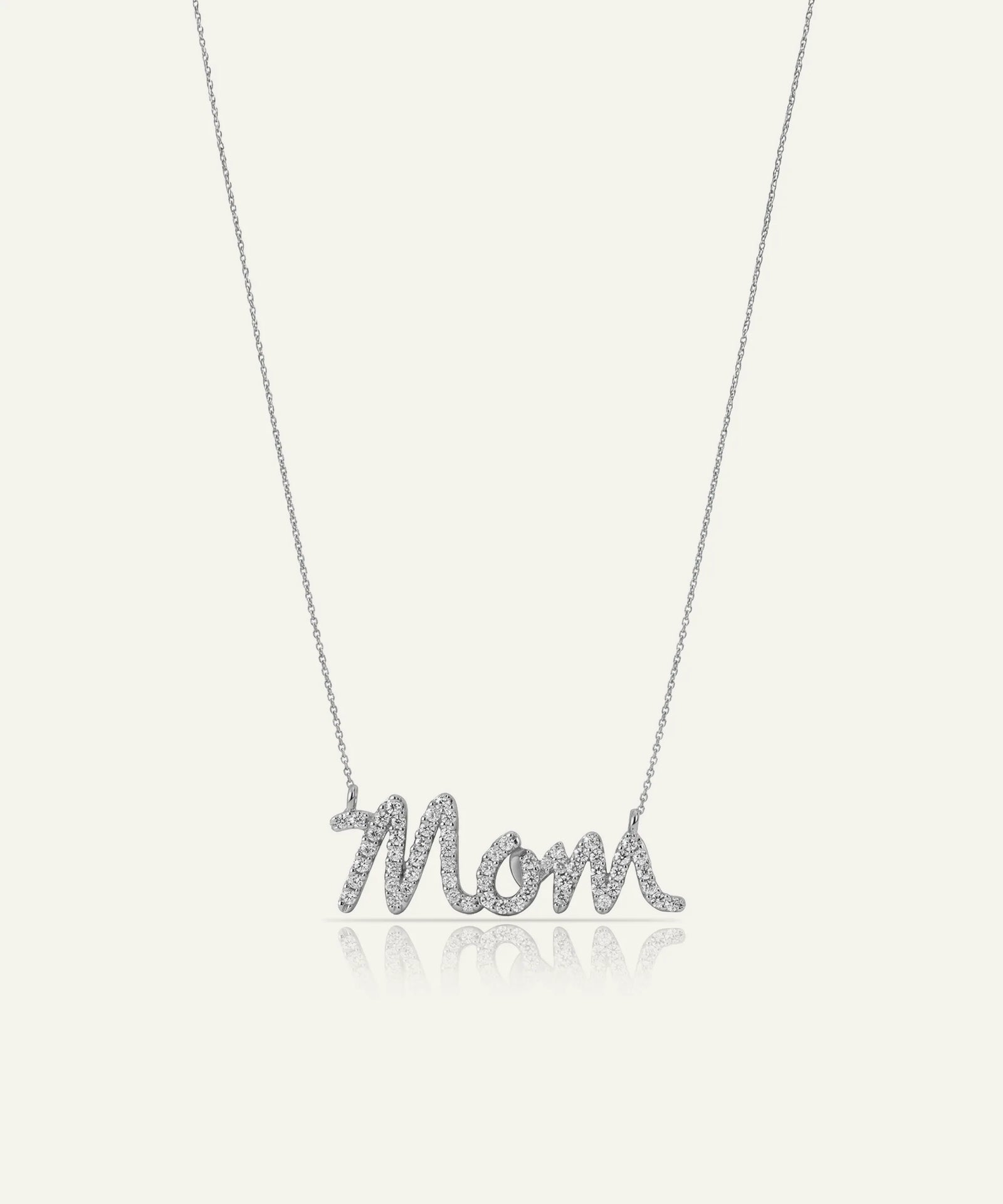 Silver 'Mom' necklace on a light gray background