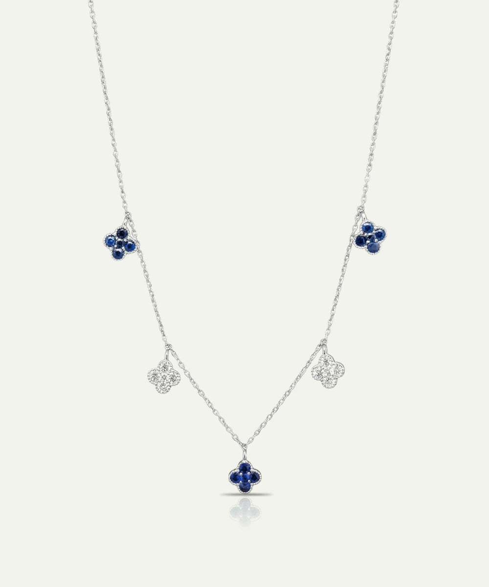 Silver necklace with blue gemstone pendants on a white background
