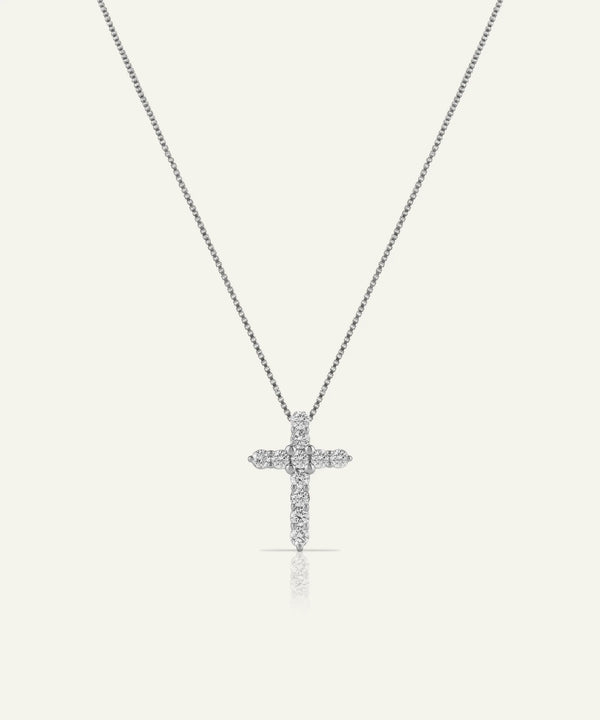 Silver cross necklace with diamonds on a light gray background
