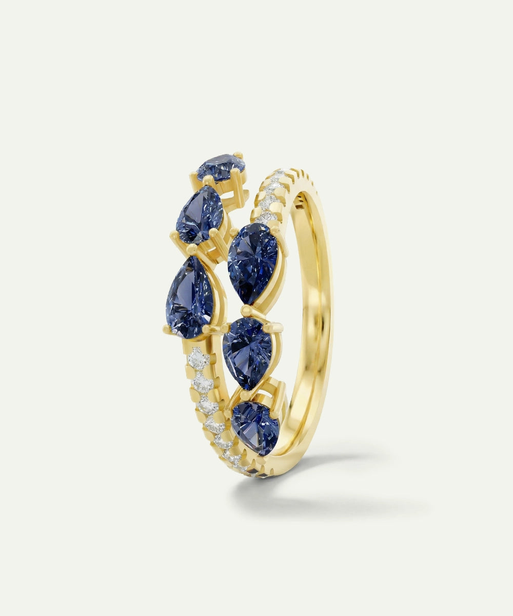 Gold ring with blue gemstones on a white background