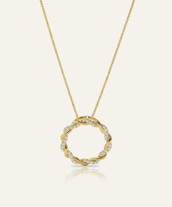 Gold necklace with a circular pendant on a white background