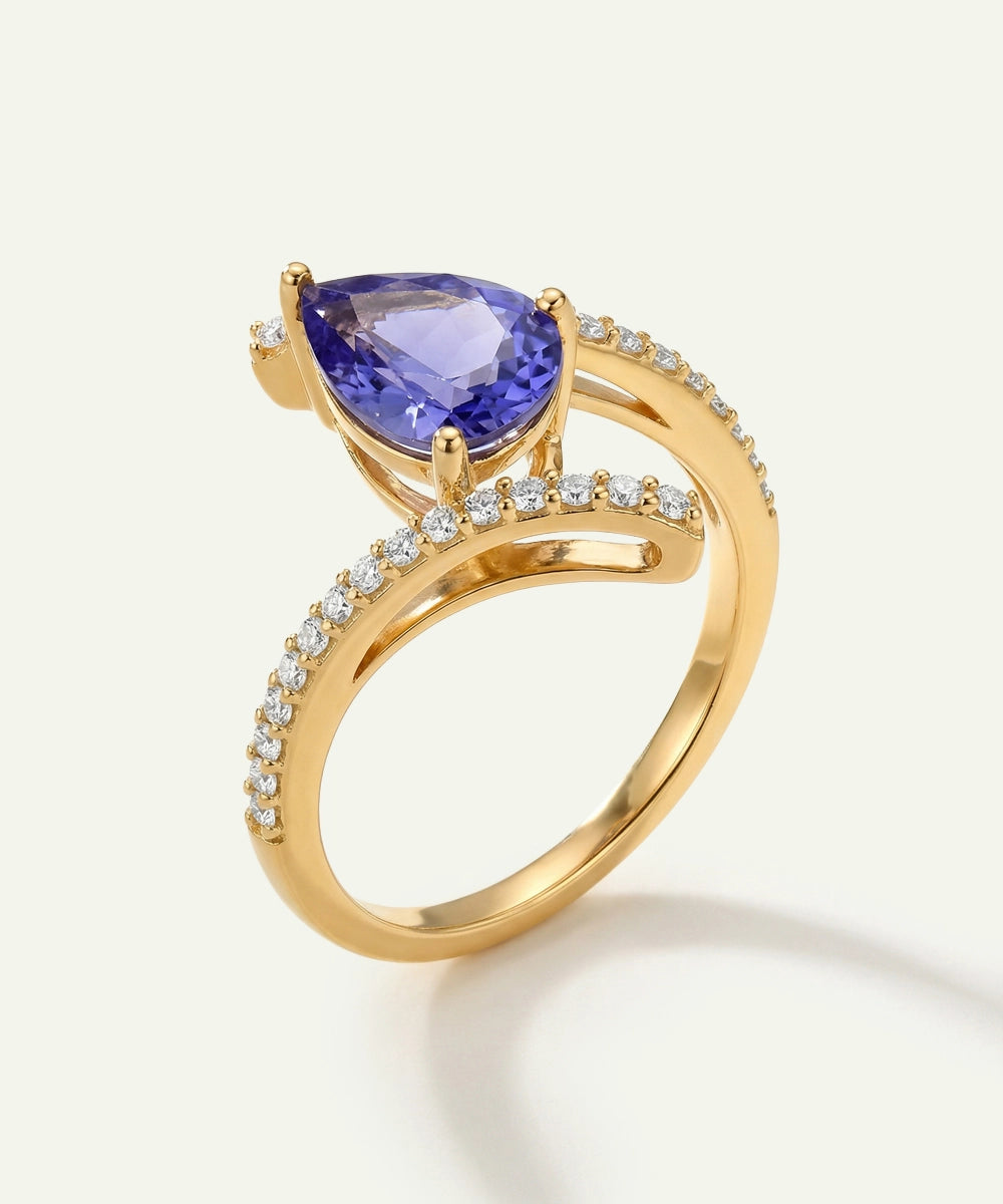 Gold ring with a purple gemstone on a white background