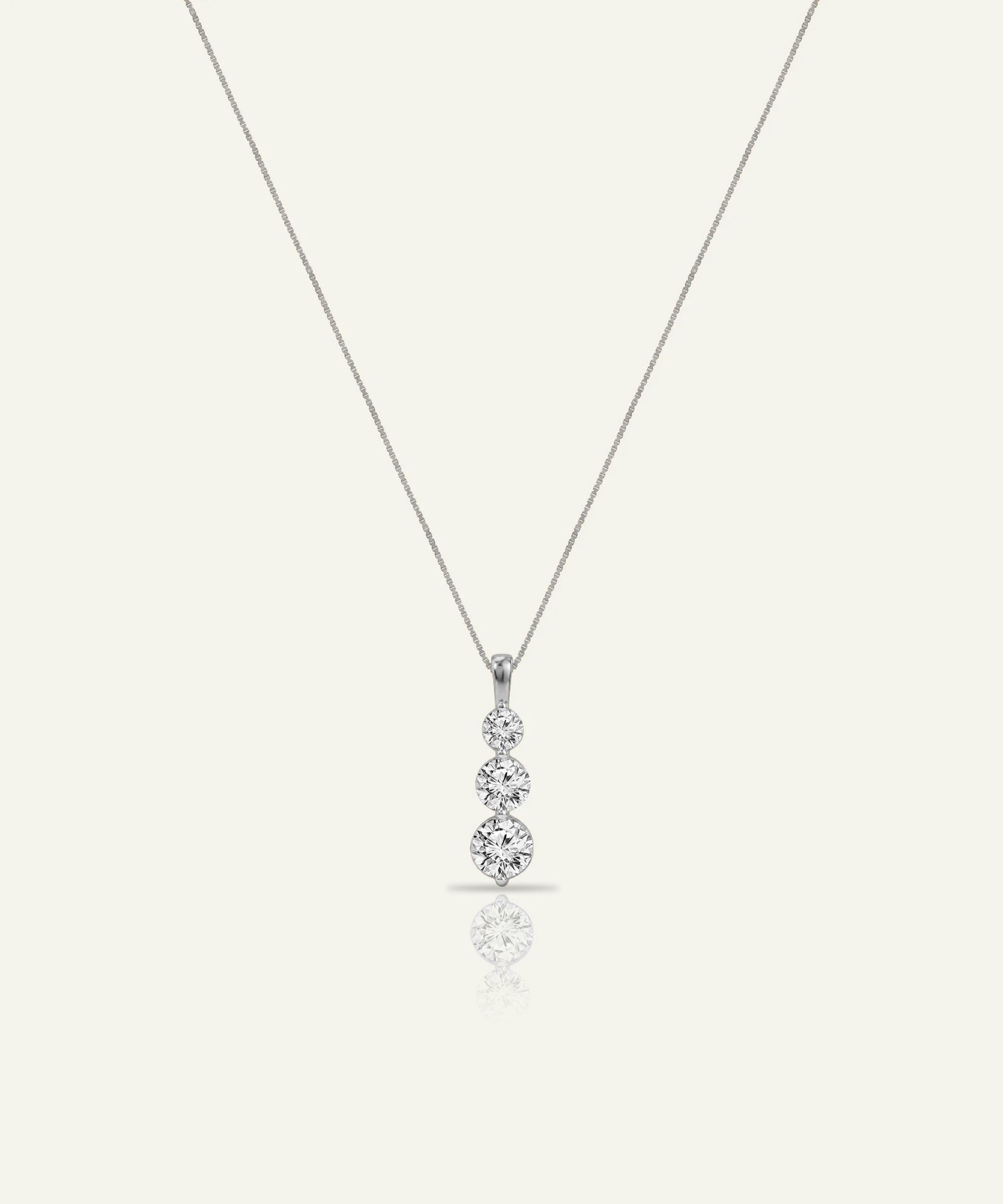 Diamond teardrop pendant on a chain against a white background