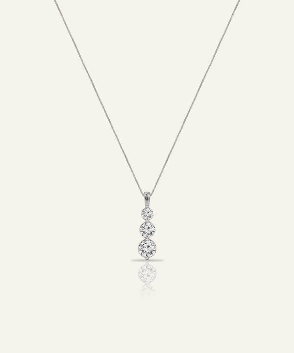 Diamond teardrop pendant on a chain against a white background
