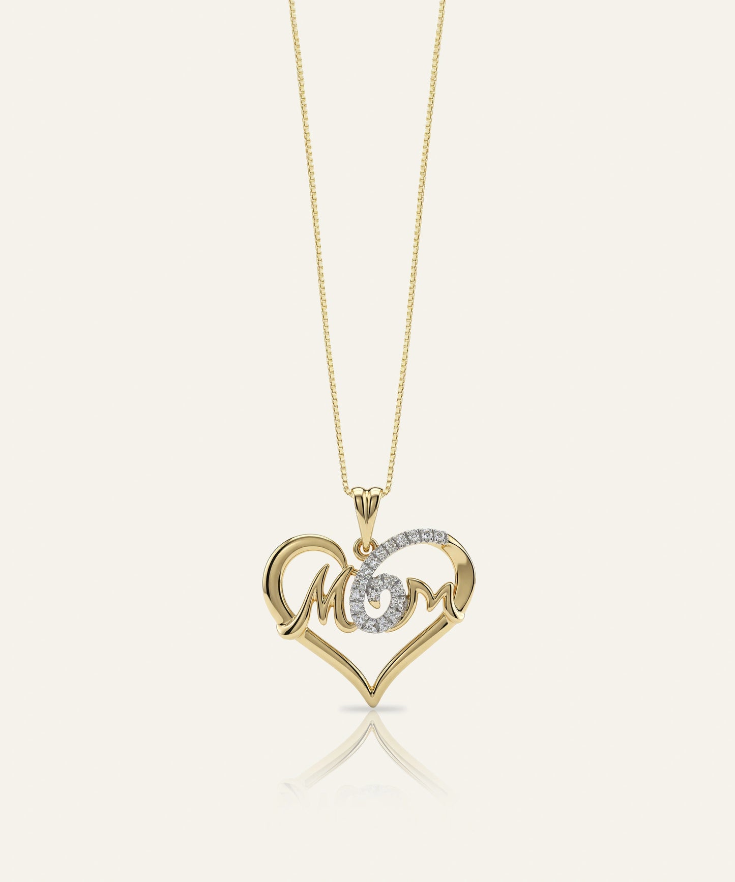 Gold necklace with a heart-shaped pendant featuring the word 'MOM'.