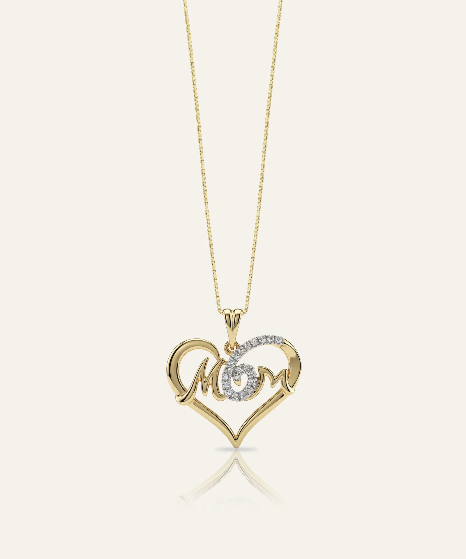 Gold necklace with a heart-shaped pendant featuring the word 'MOM'.