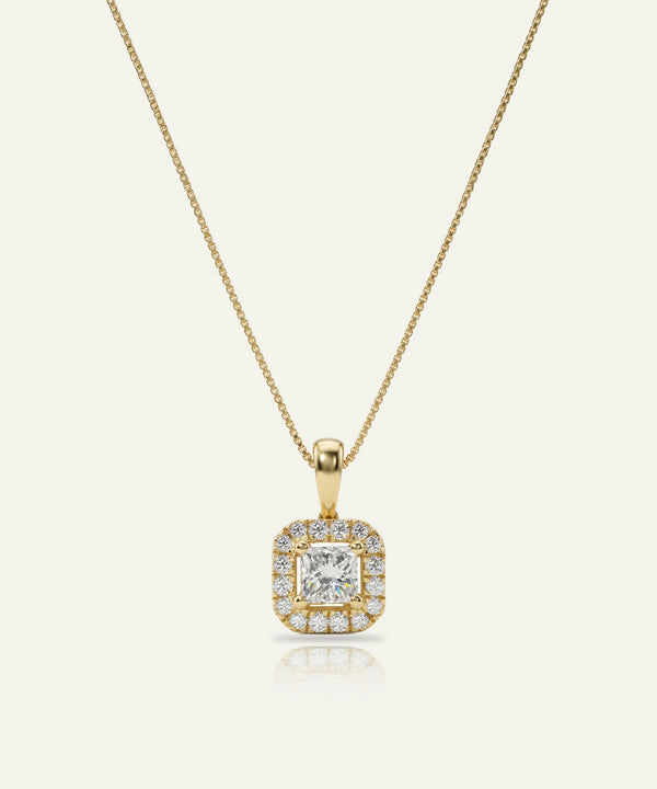 Gold necklace with a diamond pendant on a white background
