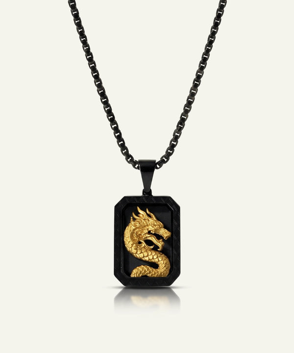 Black and gold dragon pendant necklace on a white background