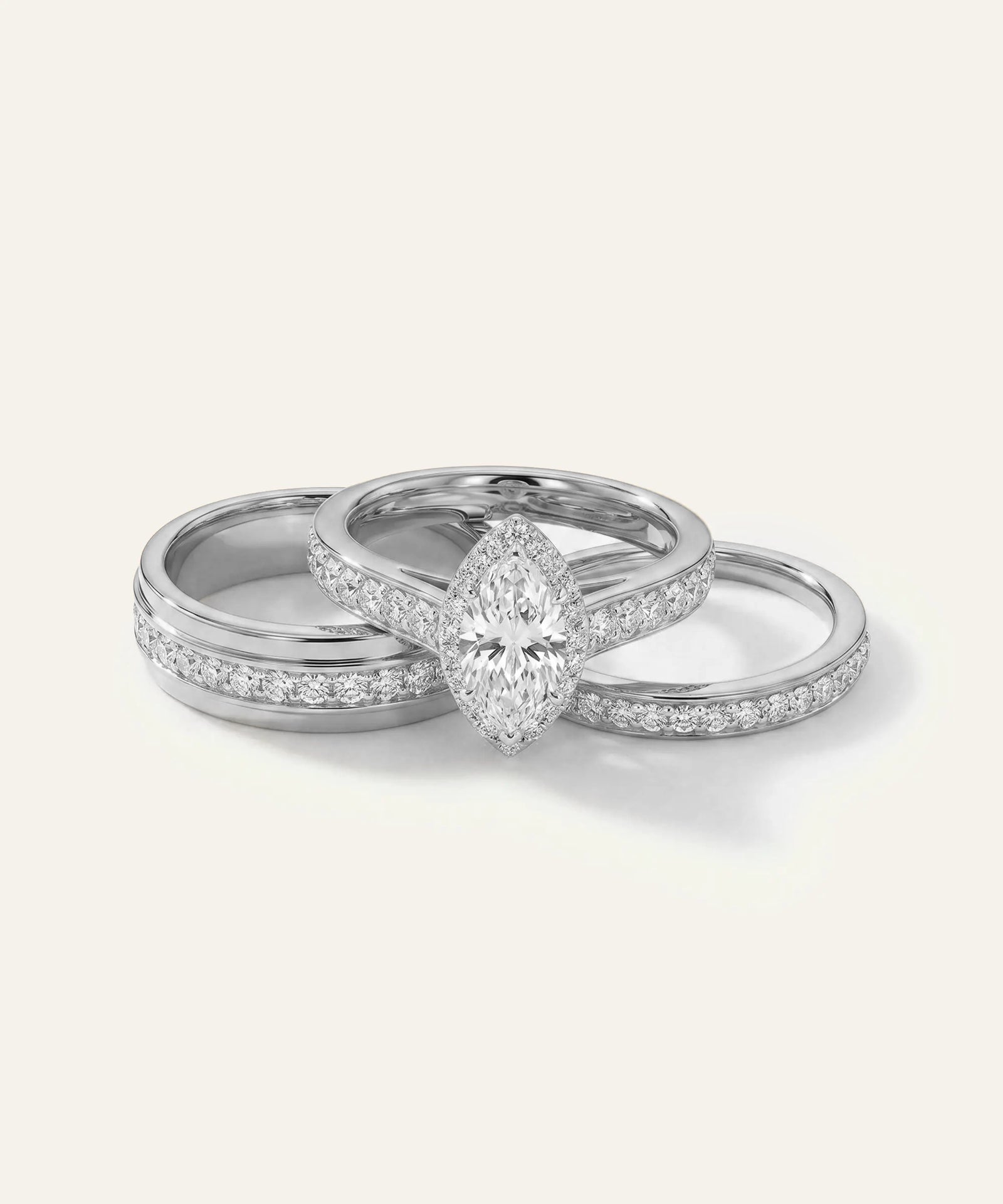 Two silver rings with diamond accents on a light gray background