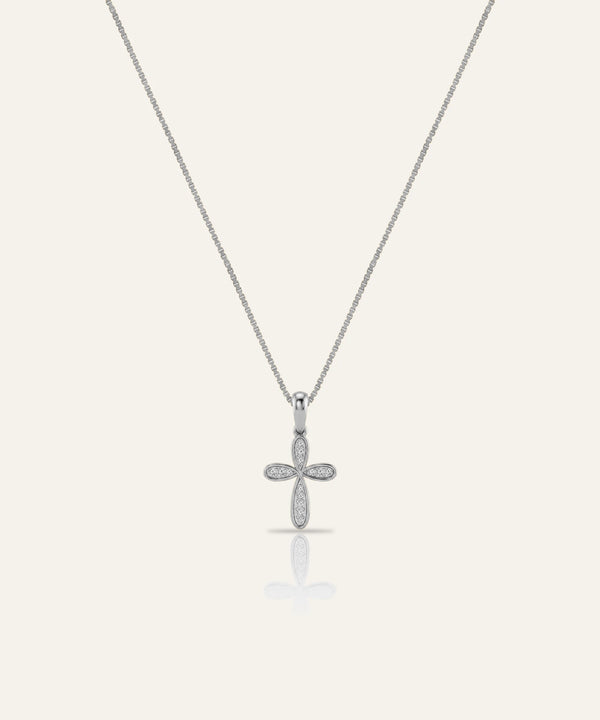 Silver cross pendant necklace on a light gray background