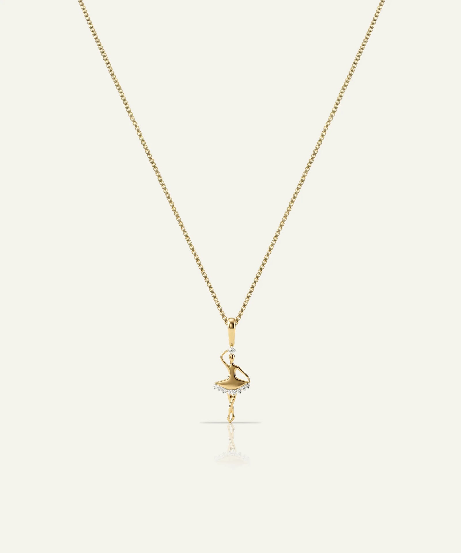 Gold necklace with a delicate pendant on a white background