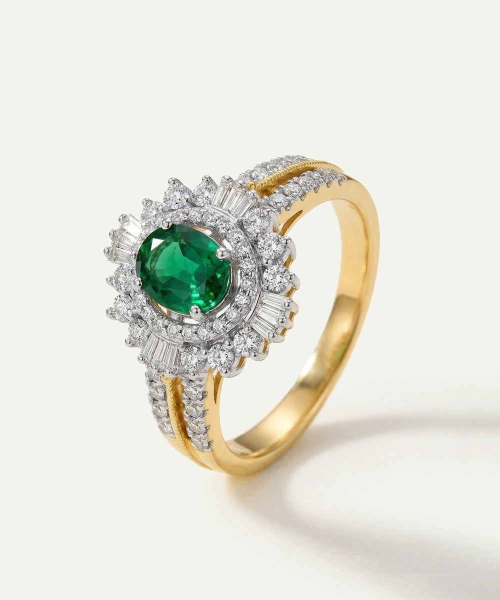 Gold ring with a green gemstone and diamond accents on a white background