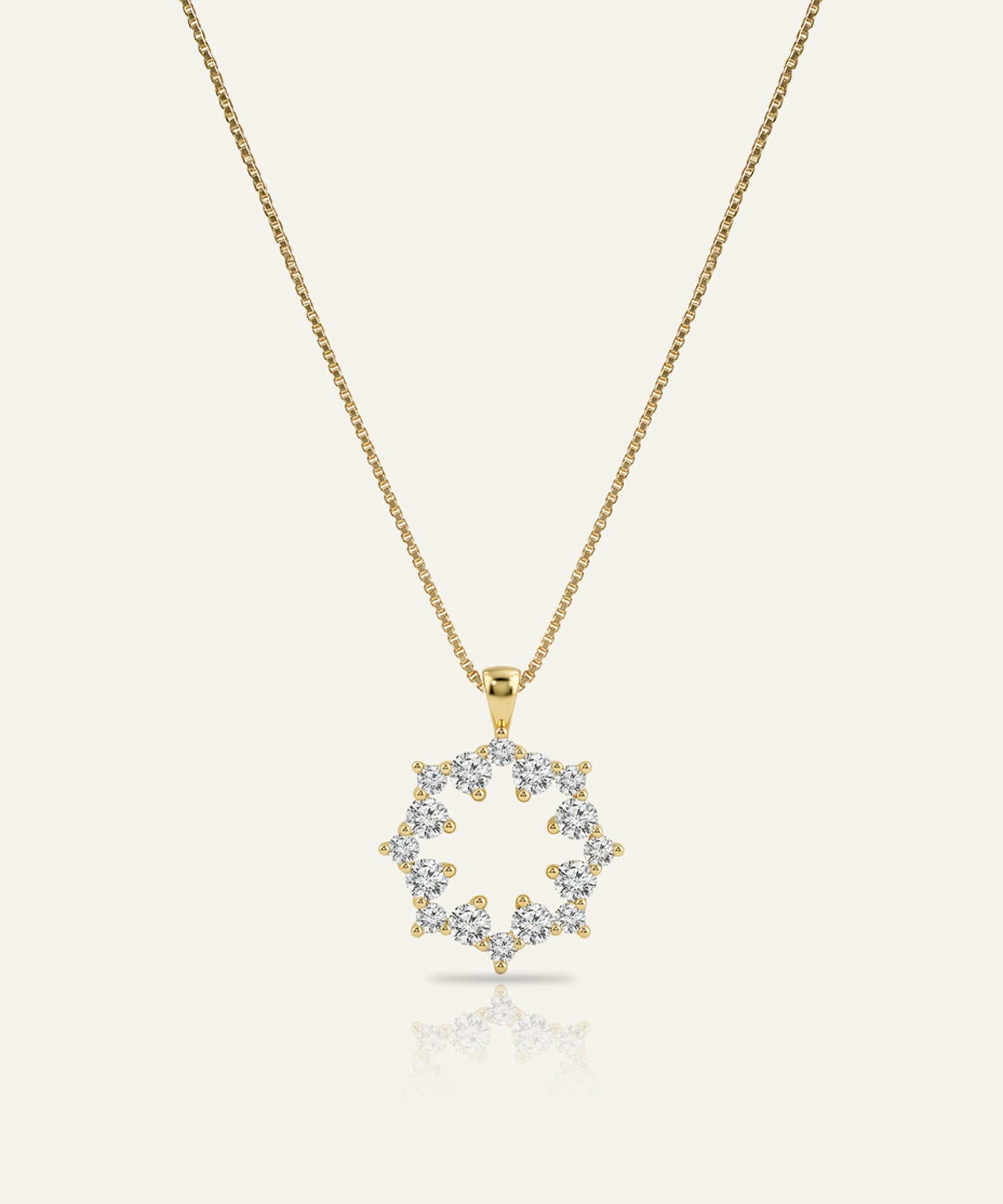 Gold necklace with a diamond pendant on a white background