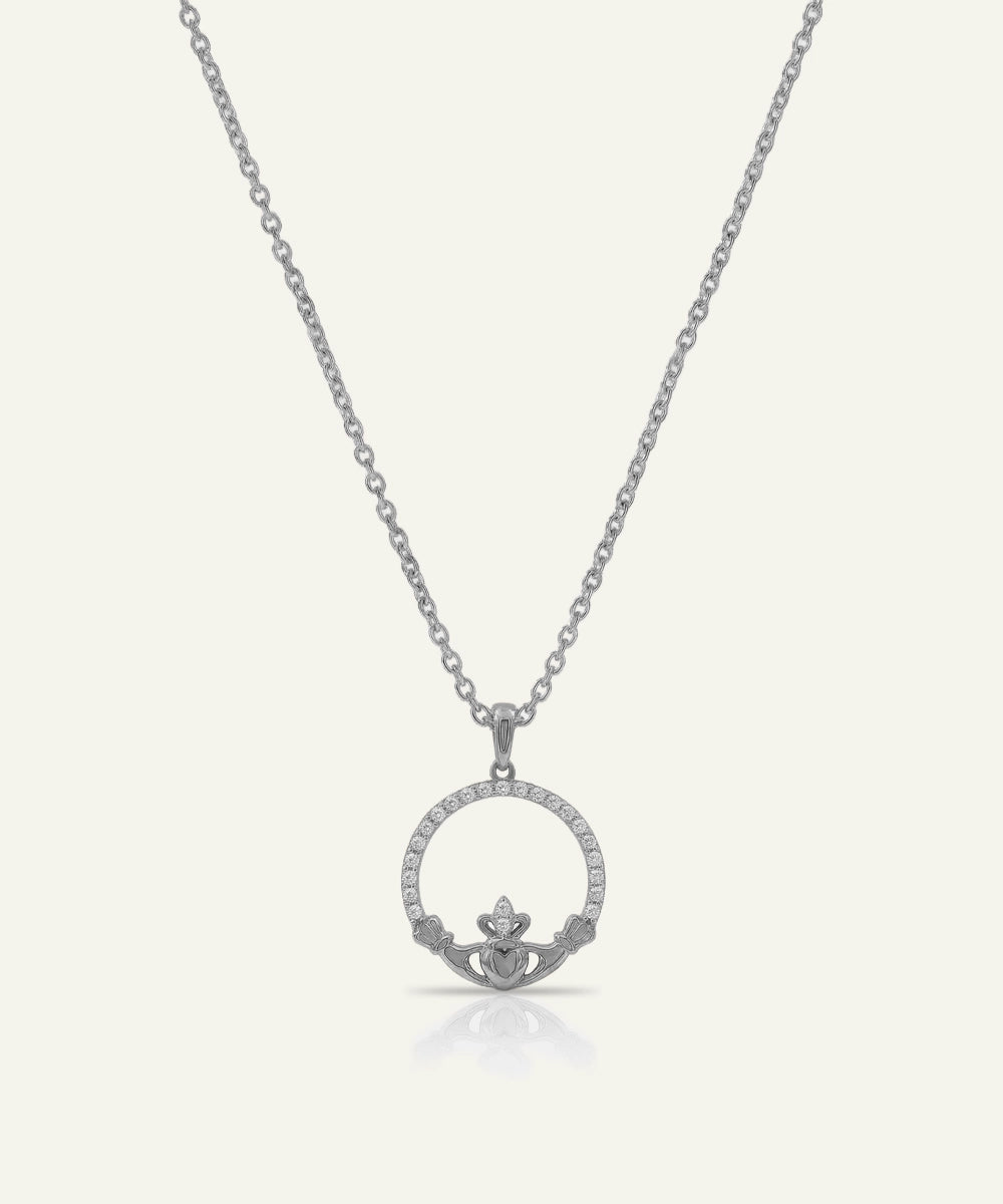 Silver claddagh pendant necklace on a white background