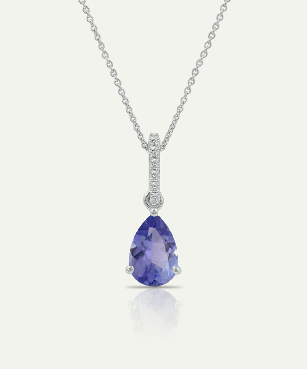 Teardrop-shaped purple gemstone pendant on a silver chain against a white background