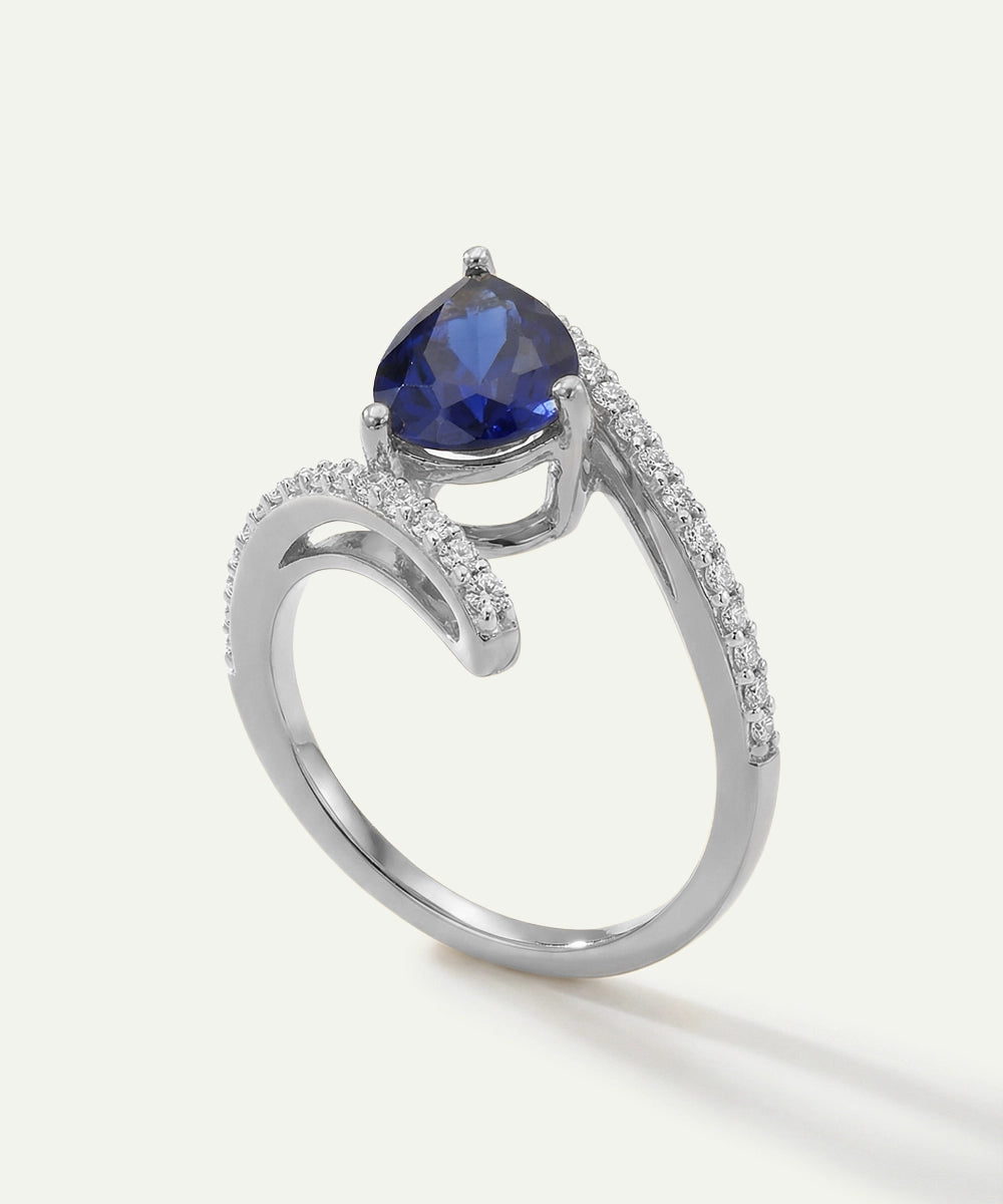 Silver ring with a blue gemstone on a white background