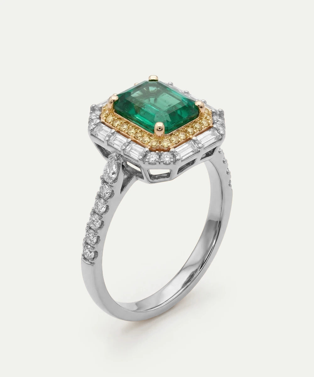 Ring with a green gemstone and diamond accents on a white background