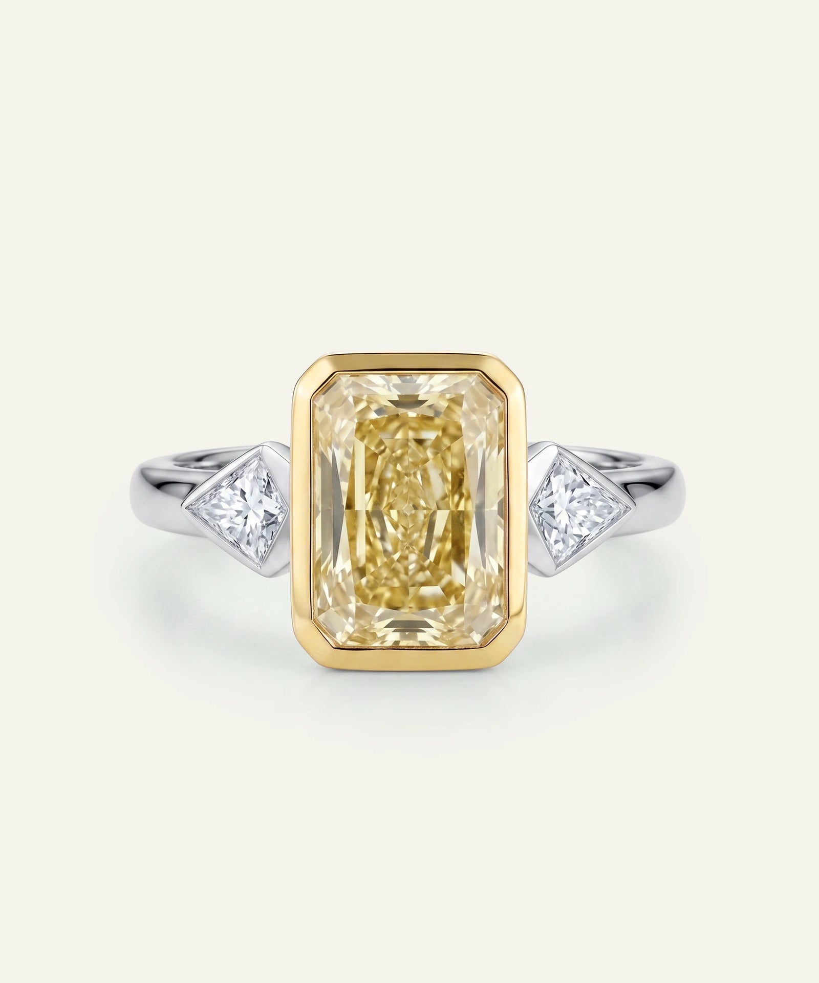 Gold ring with a large diamond and smaller diamonds on a white background