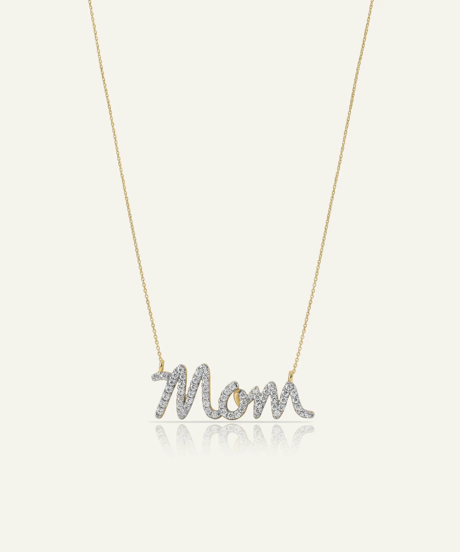 Necklace with 'Mom' pendant on a light gray background
